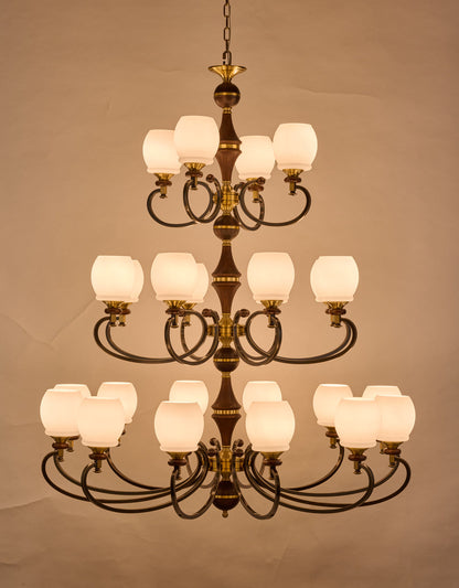 Real front photograph of the Briarwood 12 plus 8 plus 4 light three-tier chandelier illuminated
